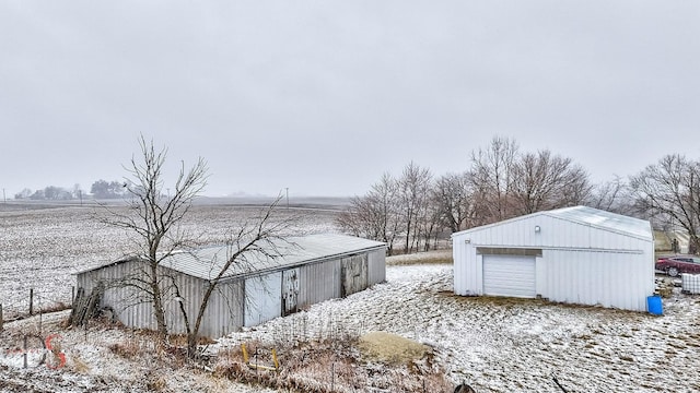 22386 N 3400 E Rd, Emington, IL 60934 - yard layered in snow with a detached garage and an outbuilding