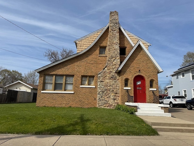 610 E Benton St, Aurora, IL 60505 - tudor home with a chimney and brick siding