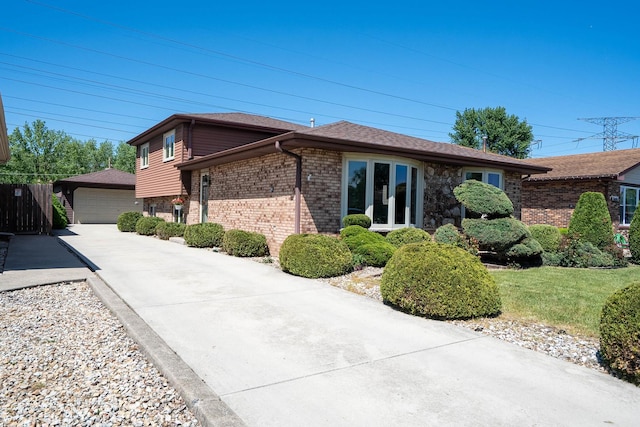 5922 W 75th Pl, Burbank, IL 60459 - view of property exterior with brick siding, a detached garage, and an outdoor structure