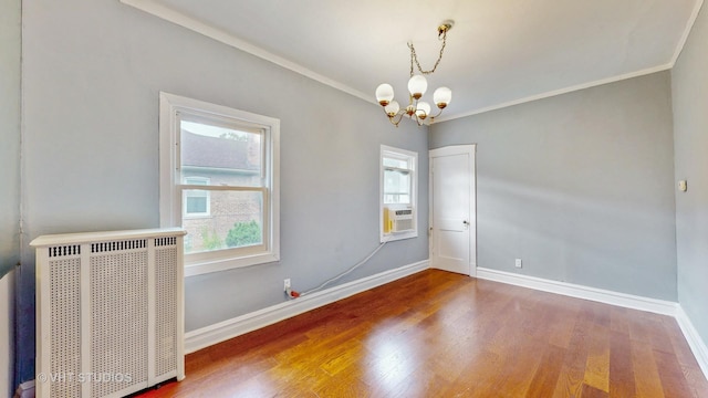 7832 S Paxton Ave, Chicago, IL 60649 - spare room featuring a chandelier, healthy amount of natural light, radiator heating unit, wood finished floors, and crown molding