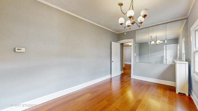 7832 S Paxton Ave, Chicago, IL 60649 - spare room with a chandelier, wood finished floors, and ornamental molding