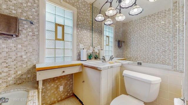 7832 S Paxton Ave, Chicago, IL 60649 - bathroom featuring tile walls, vanity, wood finished floors, and a chandelier