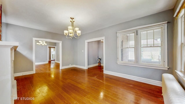 7832 S Paxton Ave, Chicago, IL 60649 - unfurnished dining area with a chandelier, radiator, and hardwood / wood-style flooring