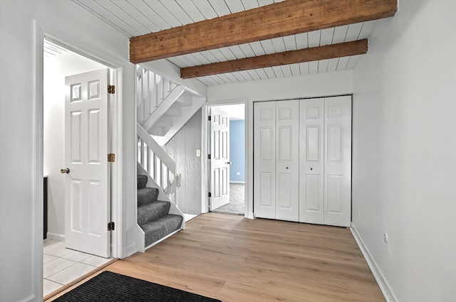 126 Cora Ave Unit D, Fox Lake, IL 60020 - foyer entrance featuring stairs, light wood-type flooring, baseboards, and wood ceiling with exposed beams
