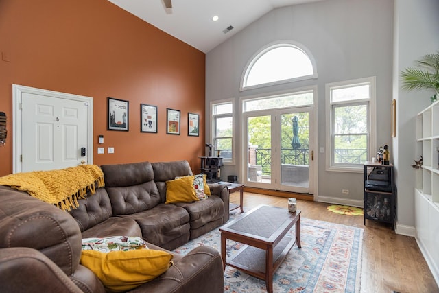 4541 N Malden St Unit 3N, Chicago, IL 60640 - living room featuring high vaulted ceiling, healthy amount of natural light, wood finished floors, a ceiling fan, and baseboards