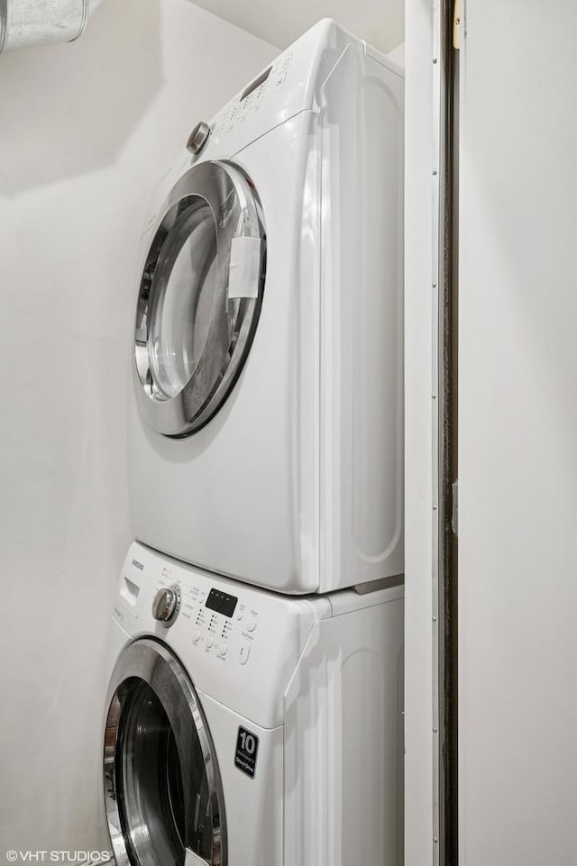 laundry area with stacked washer and clothes dryer