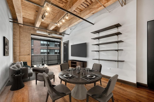 dining area with wood ceiling with exposed beams, track lighting, wood finished floors, and baseboards