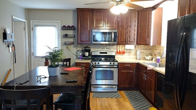432 Rose St, Bensenville, IL 60106 - kitchen featuring black appliances, a ceiling fan, wood finished floors, light countertops, and decorative backsplash
