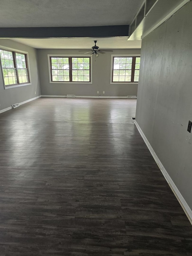 1350 N 2950 E Rd, Leroy, IL 61752 - empty room featuring dark wood-style flooring, a ceiling fan, and baseboards