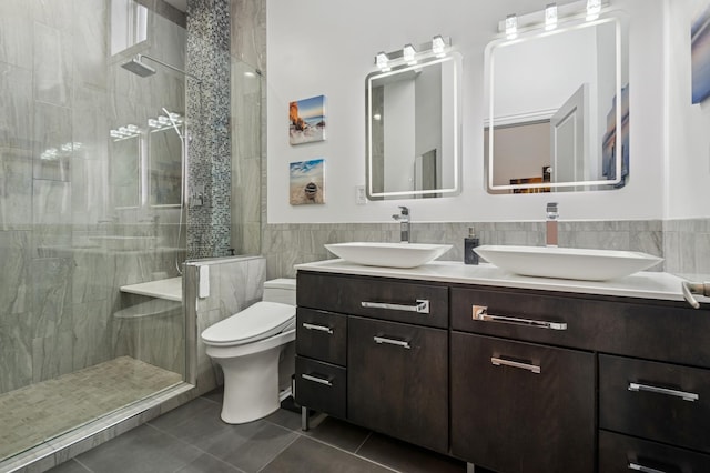7223 N Hamilton Ave Unit A, Chicago, IL 60645 - bathroom with tile walls, a stall shower, toilet, double vanity, and tile patterned flooring