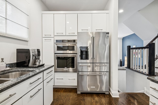 7223 N Hamilton Ave Unit A, Chicago, IL 60645 - kitchen featuring stainless steel appliances, dark stone counters, dark wood finished floors, white cabinets, and recessed lighting