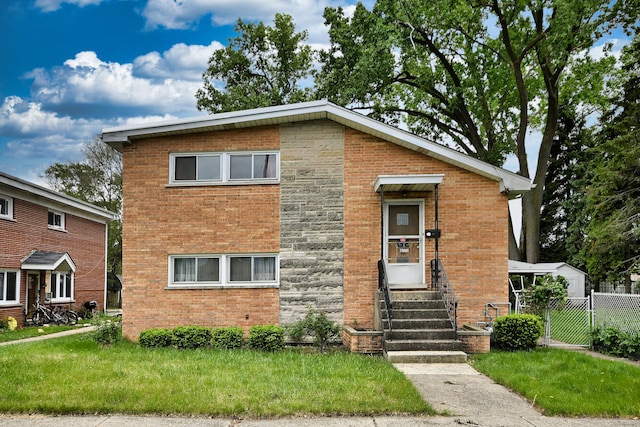 10009 W Fullerton Ave, Melrose Park, IL 60164 - tri-level home with entry steps, brick siding, a gate, and stone siding