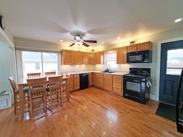 5831 W 109th St, Chicago Ridge, IL 60415 - kitchen with black appliances, a sink, light countertops, ceiling fan, and light wood-style flooring
