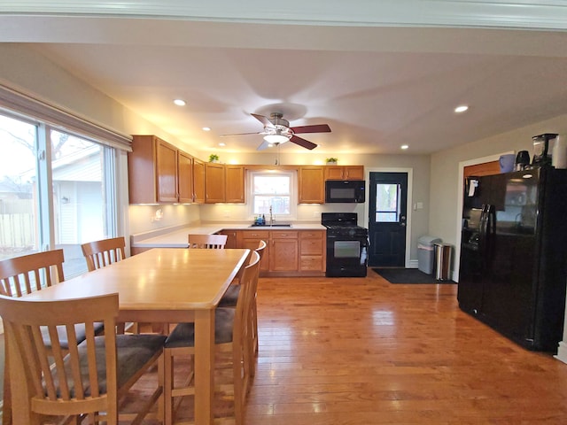 5831 W 109th St, Chicago Ridge, IL 60415 - kitchen with black appliances, light countertops, a sink, light wood-style flooring, and recessed lighting