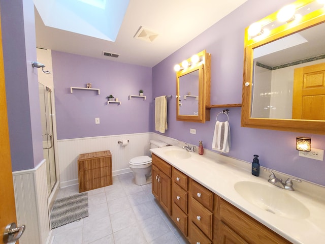 5831 W 109th St, Chicago Ridge, IL 60415 - bathroom featuring a wainscoted wall, toilet, a stall shower, a skylight, and double vanity