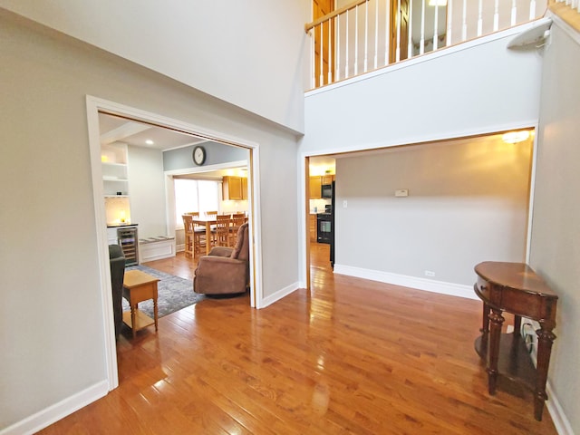 5831 W 109th St, Chicago Ridge, IL 60415 - living area with beverage cooler, wood finished floors, baseboards, and a high ceiling