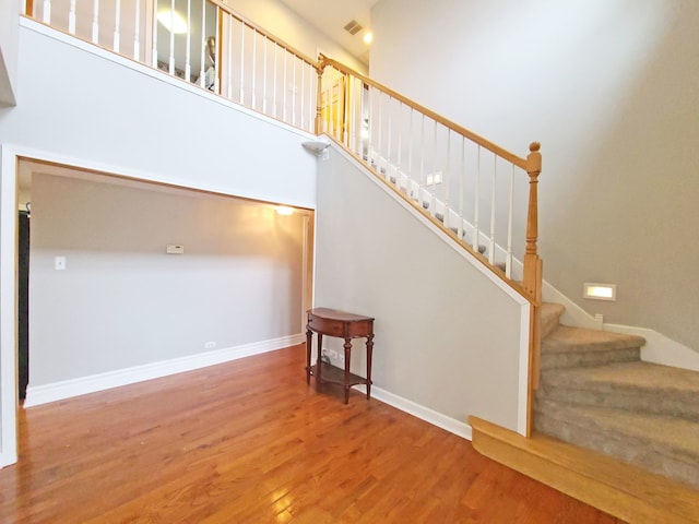 5831 W 109th St, Chicago Ridge, IL 60415 - stairway with wood finished floors, baseboards, and a towering ceiling