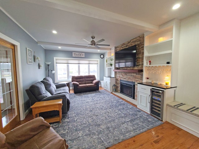 5831 W 109th St, Chicago Ridge, IL 60415 - living area with beverage cooler, a bar, wood finished floors, ceiling fan, and a stone fireplace