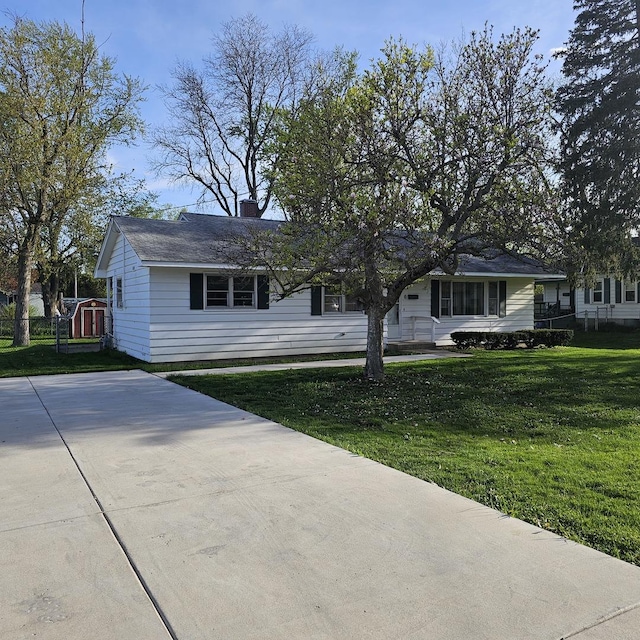 6 Johnson St, East Dundee, IL 60118 - view of front of property with a front yard, a chimney, and concrete driveway