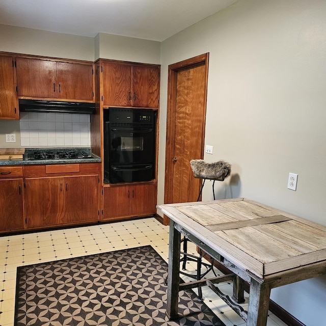 6 Johnson St, East Dundee, IL 60118 - kitchen with black appliances, a warming drawer, dark countertops, decorative backsplash, and light flooring