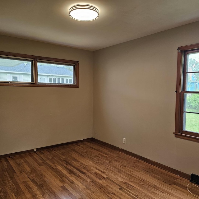 6 Johnson St, East Dundee, IL 60118 - spare room with dark wood finished floors, baseboards, and healthy amount of natural light