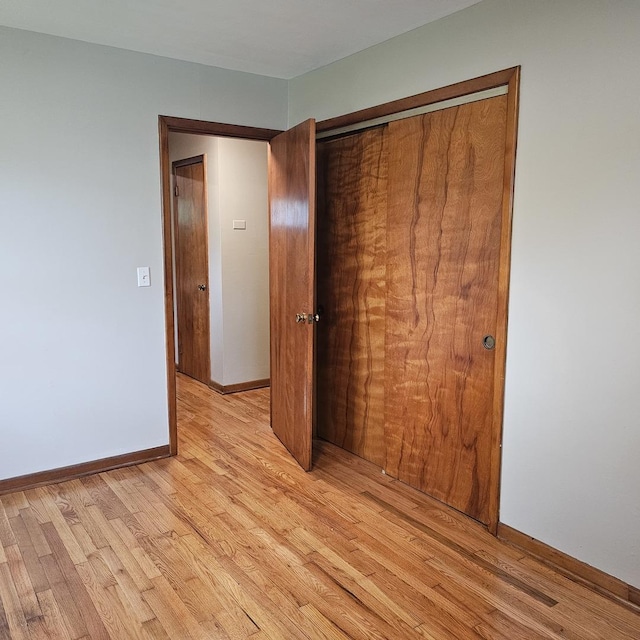 6 Johnson St, East Dundee, IL 60118 - unfurnished bedroom featuring light wood-style floors, a closet, and baseboards