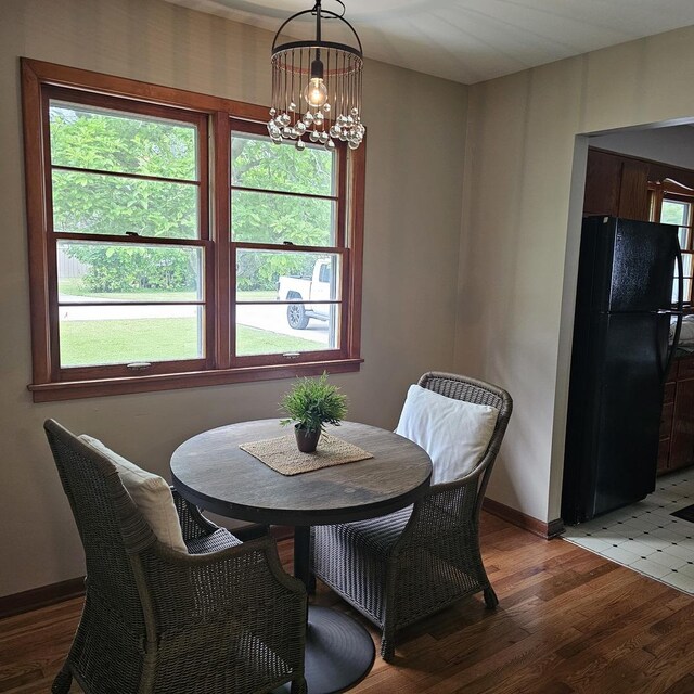 6 Johnson St, East Dundee, IL 60118 - dining area featuring a chandelier, light wood finished floors, and baseboards