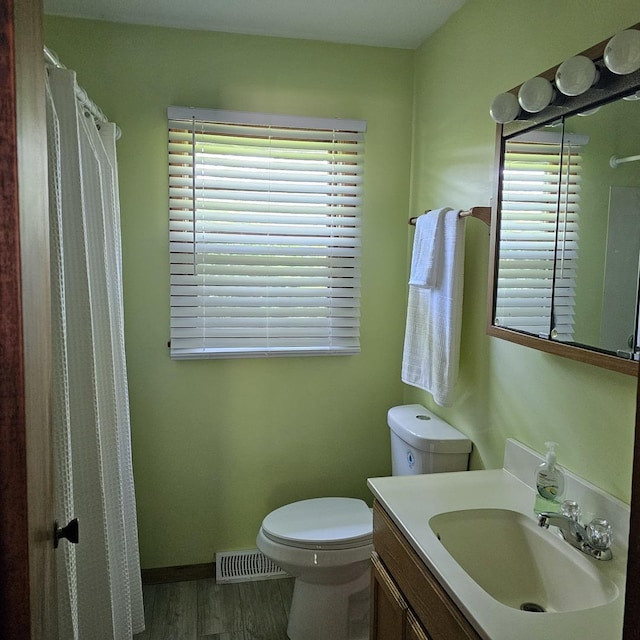 6 Johnson St, East Dundee, IL 60118 - bathroom with toilet, vanity, wood finished floors, a shower with curtain, and baseboards