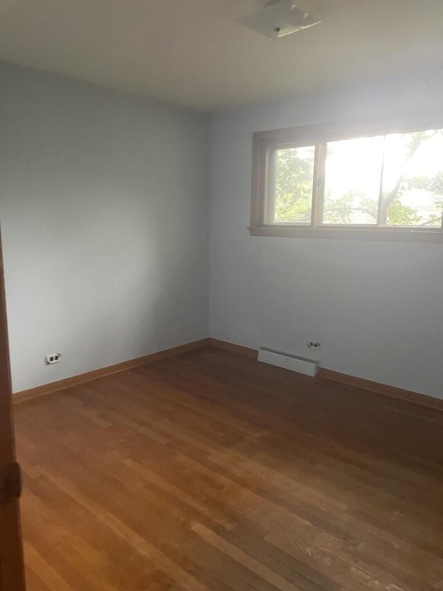 11011 W Roosevelt Rd, Westchester, IL 60154 - unfurnished room with a baseboard radiator and wood finished floors