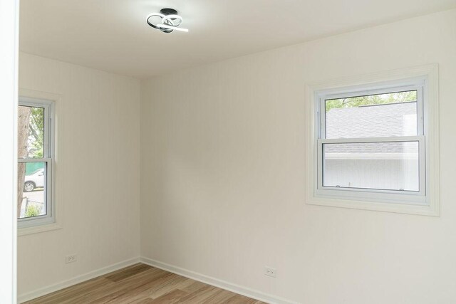 906 Central Park Dr, Round Lake Beach, IL 60073 - spare room featuring light wood-type flooring and baseboards