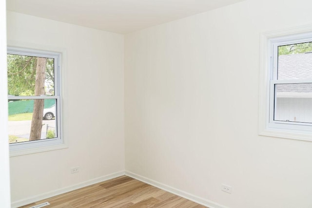 906 Central Park Dr, Round Lake Beach, IL 60073 - empty room with light wood-style floors, baseboards, and healthy amount of natural light