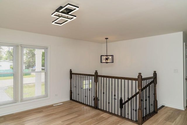 906 Central Park Dr, Round Lake Beach, IL 60073 - stairs with wood finished floors, a chandelier, and baseboards