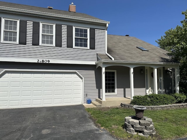 2S809 Grove Ln, Warrenville, IL 60555 - view of front of home with a porch, a chimney, an attached garage, driveway, and roof with shingles