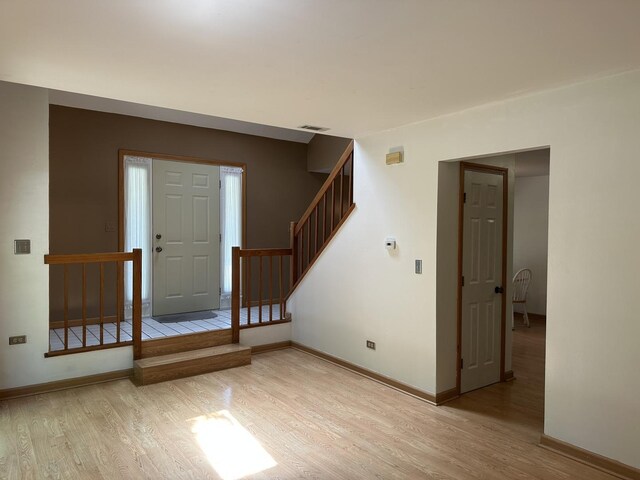 2S809 Grove Ln, Warrenville, IL 60555 - entrance foyer featuring light wood finished floors, stairway, and baseboards