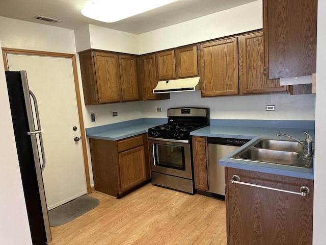 2S809 Grove Ln, Warrenville, IL 60555 - kitchen with appliances with stainless steel finishes, range hood, light wood-style floors, and a sink