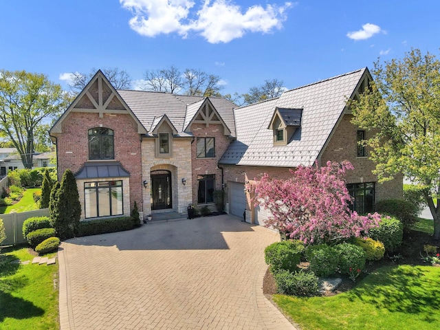 610 Greendale Rd, Glenview, IL 60025 - tudor home featuring decorative driveway, an attached garage, a high end roof, and brick siding