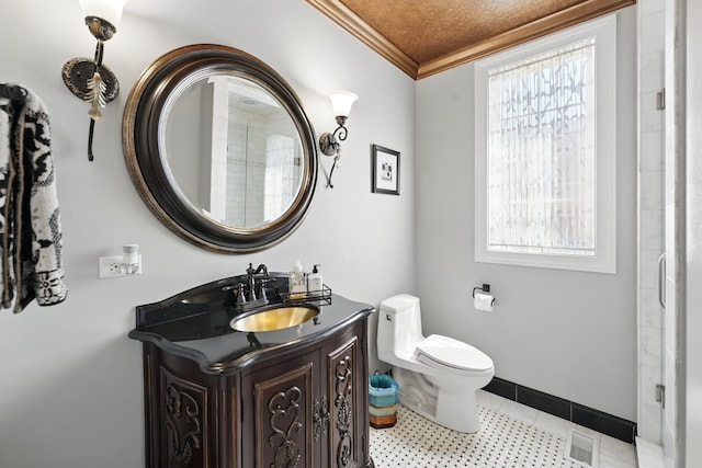 610 Greendale Rd, Glenview, IL 60025 - bathroom featuring ornamental molding, vanity, toilet, baseboards, and tile patterned flooring