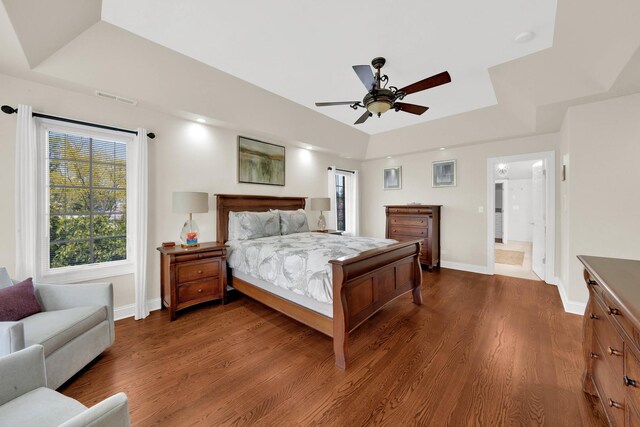 610 Greendale Rd, Glenview, IL 60025 - bedroom featuring a tray ceiling, baseboards, dark wood-style floors, and ceiling fan