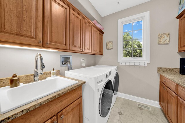 610 Greendale Rd, Glenview, IL 60025 - laundry room with washer and clothes dryer, cabinet space, baseboards, and light tile patterned floors
