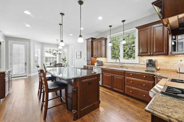 610 Greendale Rd, Glenview, IL 60025 - kitchen featuring a sink, wood finished floors, dishwasher, decorative backsplash, and recessed lighting
