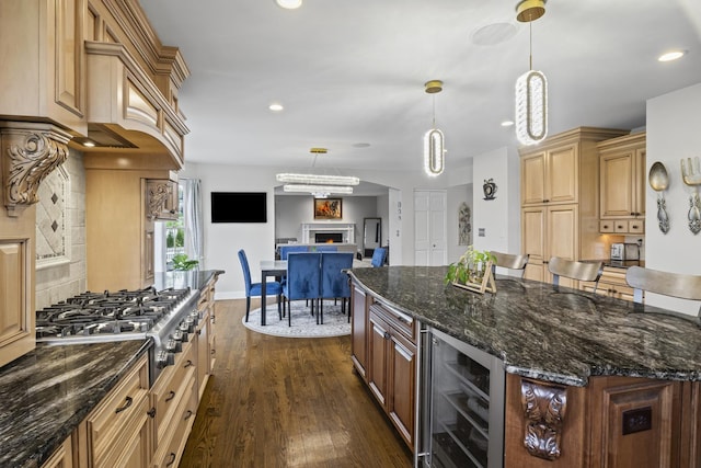 1086 Brighton Dr, Carol Stream, IL 60188 - kitchen with wine cooler, stainless steel gas cooktop, dark wood finished floors, recessed lighting, and a warm lit fireplace