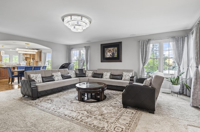 1086 Brighton Dr, Carol Stream, IL 60188 - carpeted living area featuring arched walkways, a chandelier, healthy amount of natural light, and baseboards