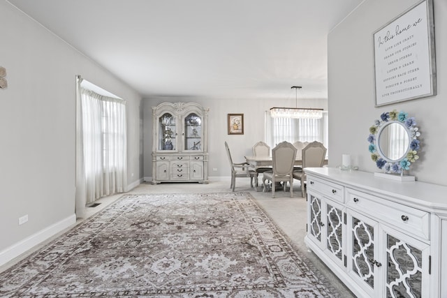 1086 Brighton Dr, Carol Stream, IL 60188 - living area with light carpet, a chandelier, and baseboards