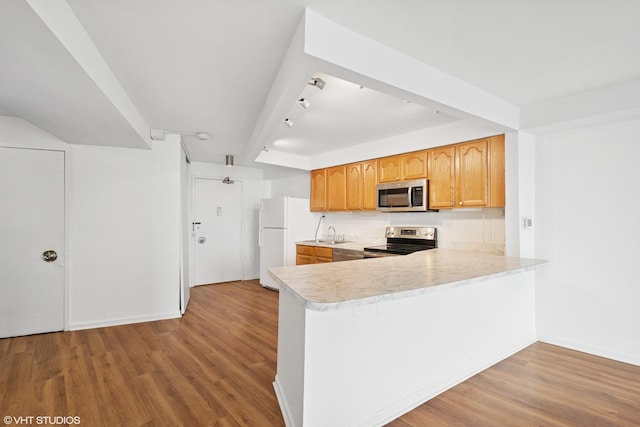 300 N State St Unit 3205, Chicago, IL 60654 - kitchen with stainless steel appliances, light countertops, wood finished floors, and a sink