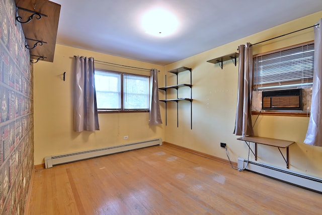 2808 Struckman Ave, River Grove, IL 60171 - unfurnished room featuring a baseboard heating unit, wood finished floors, and cooling unit