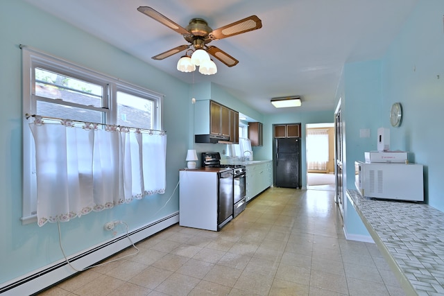 2808 Struckman Ave, River Grove, IL 60171 - kitchen with gas range, a baseboard radiator, freestanding refrigerator, under cabinet range hood, and a ceiling fan