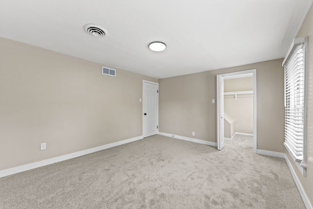 217 W Mazon Ave, Dwight, IL 60420 - unfurnished bedroom with light carpet, a walk in closet, baseboards, and a closet