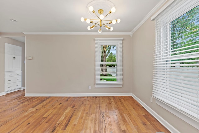 217 W Mazon Ave, Dwight, IL 60420 - unfurnished room featuring crown molding, a chandelier, light wood-style flooring, and baseboards