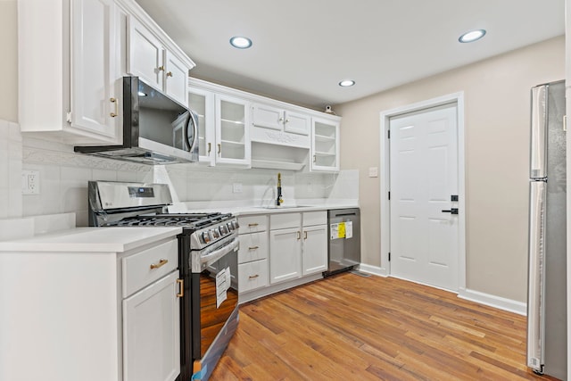 217 W Mazon Ave, Dwight, IL 60420 - kitchen with appliances with stainless steel finishes, a sink, light wood finished floors, white cabinets, and recessed lighting
