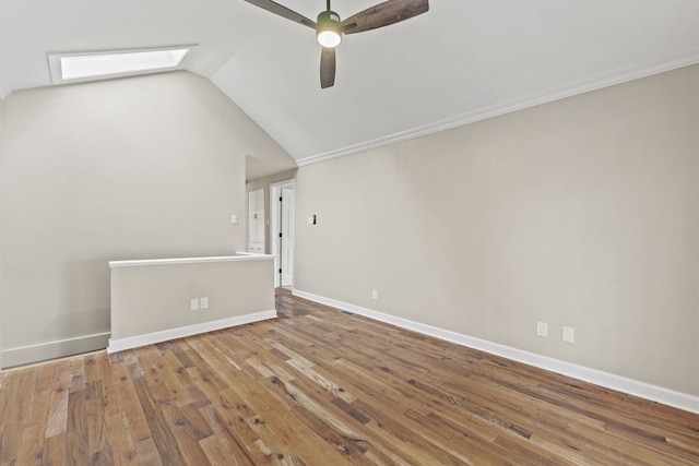 217 W Mazon Ave, Dwight, IL 60420 - spare room with a skylight, a ceiling fan, vaulted ceiling, wood finished floors, and baseboards